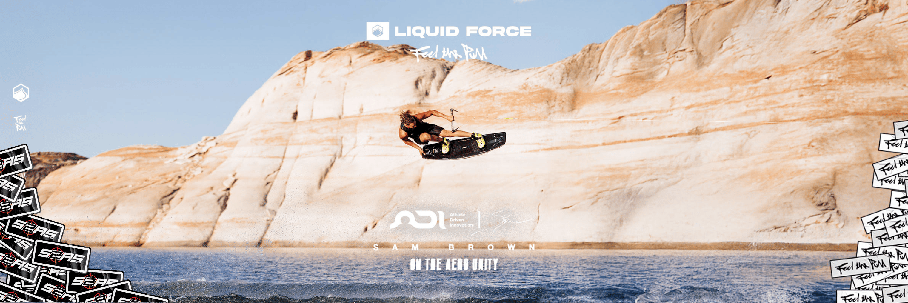 Person surfing on a wave with Liquid Force branding in the background