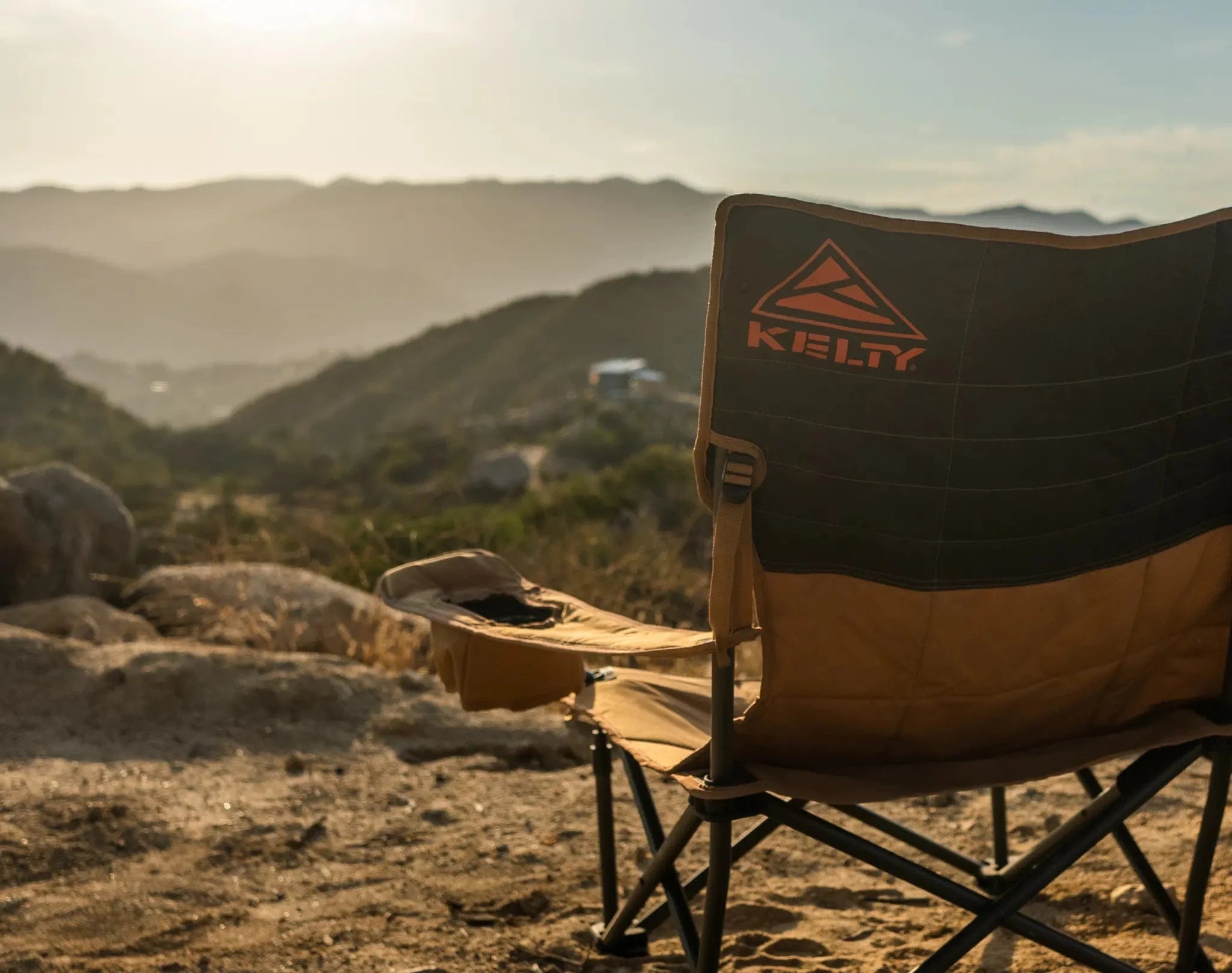Kelty chair in a desert landscape with mountains in the background